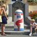 2 women and a boy stare at a painted milestone by a plaque